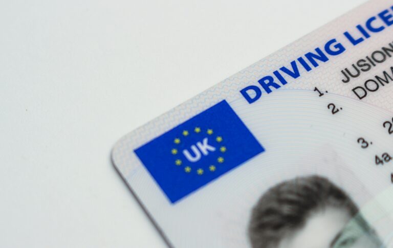Detailed photo of a UK driving license showcasing EU flag and identity features.